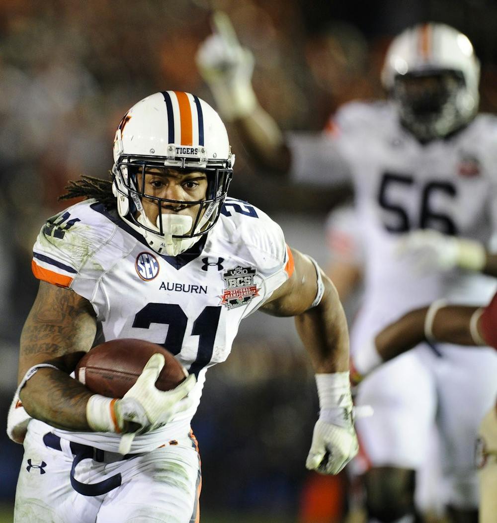 Auburn running back Tre Mason (21) runs the ball 37 yards for a  touchdown to put Auburn ahead of Florida State 31-27 with 1:19 left in the game, Pasadena, Calif., Jan. 6, 2014. (Zach Bland / Assistant Photo Editor)