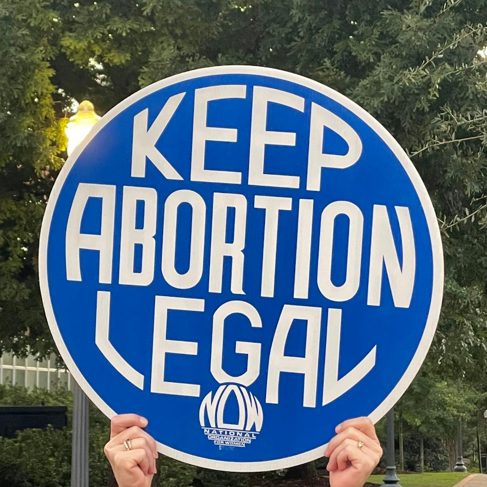 <p>A sign that reads "Keep Abortion Legal" is held at Toomer's Corner on Sept. 9, 2021.&nbsp;</p>
