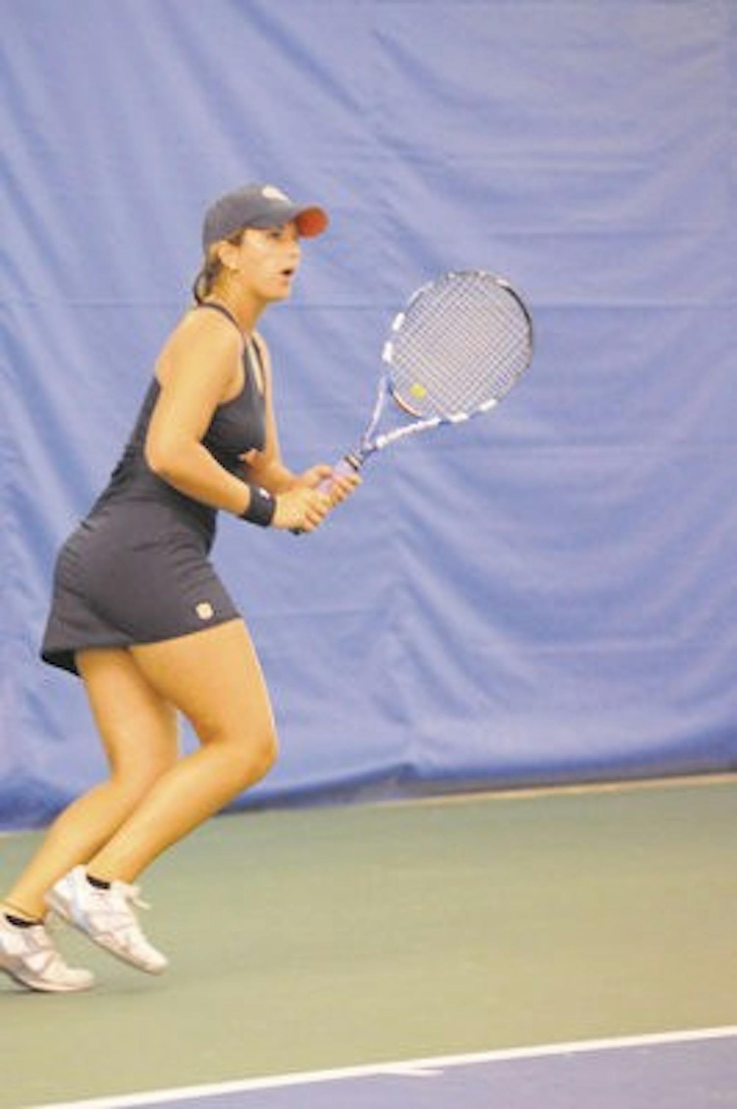 Olivia Bennett, a freshman on the women's tennis team, readies her racket at the tennis tournament Sunday. (File Photo)