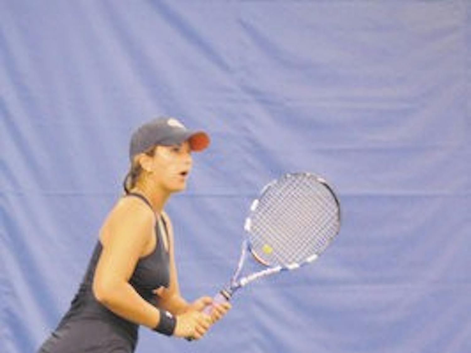 Olivia Bennett, a freshman on the women's tennis team, readies her racket at the tennis tournament Sunday. (File Photo)