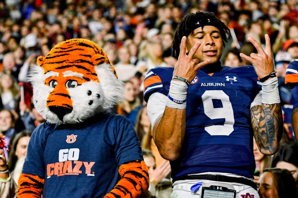 <p>QB Robby Ashford (#9) celebrates in the student section with Aubie in Jordan-Hare Stadium against Texas A&amp;M on November 12, 2022.&nbsp;</p>