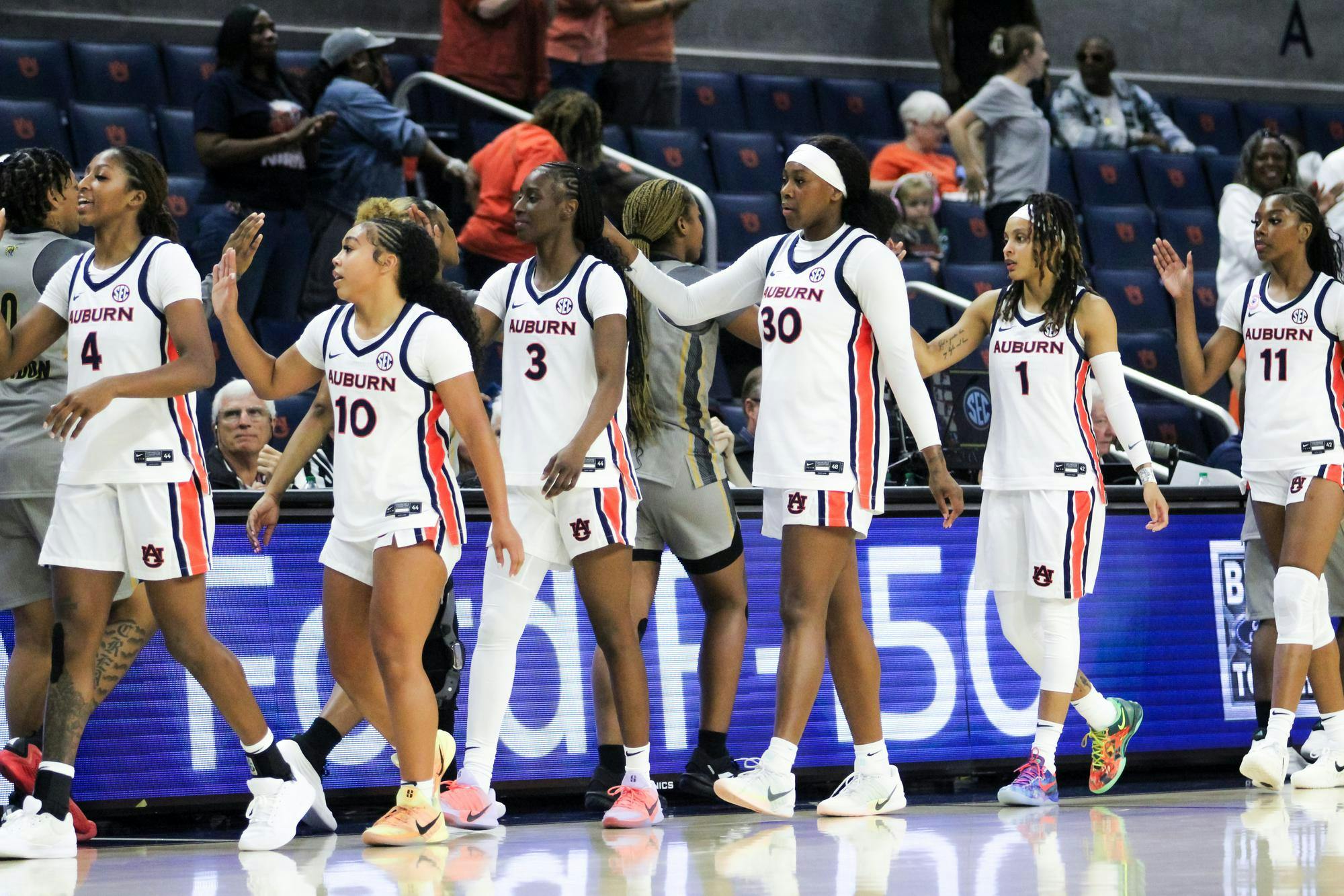 The Auburn Women's Basketball team high fives Alabama state after Auburn wins the game at Neville Arena in Auburn, Ala. on Nov. 8, 2025.