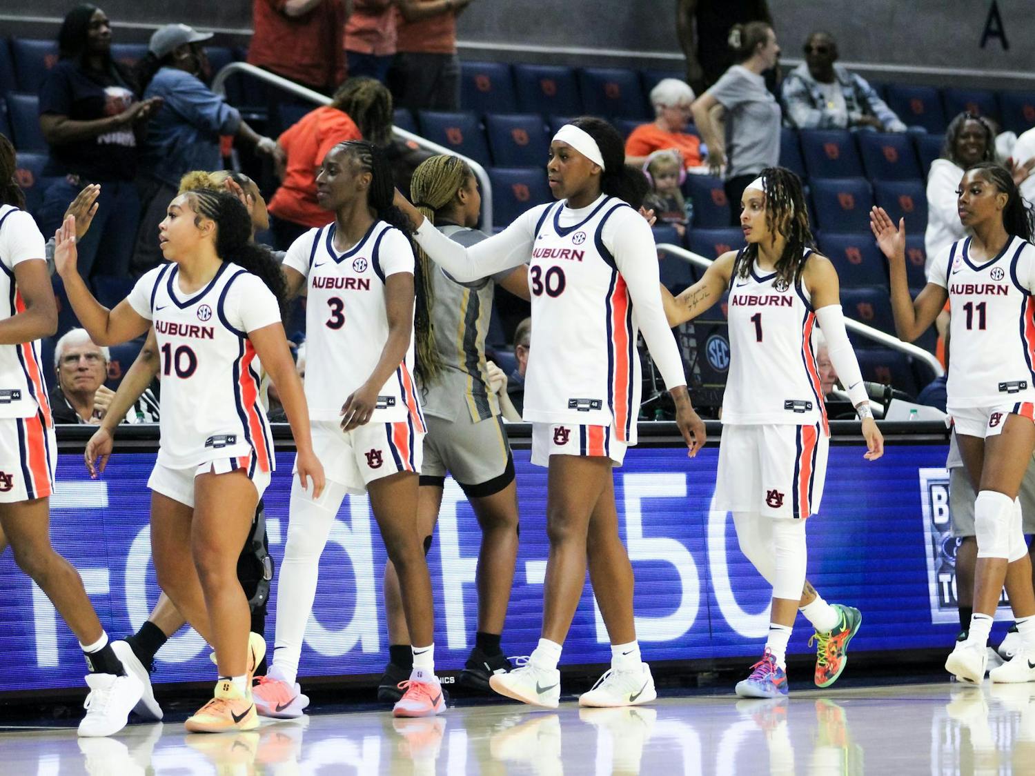 The Auburn Women's Basketball team high fives Alabama state after Auburn wins the game at Neville Arena in Auburn, Ala. on Nov. 8, 2025.