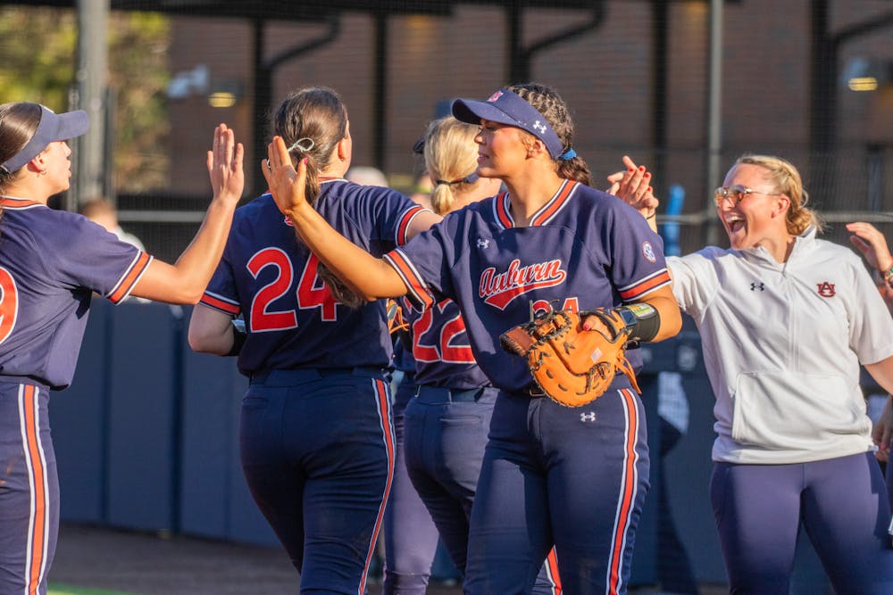 Senior infielder Amelia Lech high fives teammates before a doubleheader against SIU and UNC on Feb. 7, 2025.