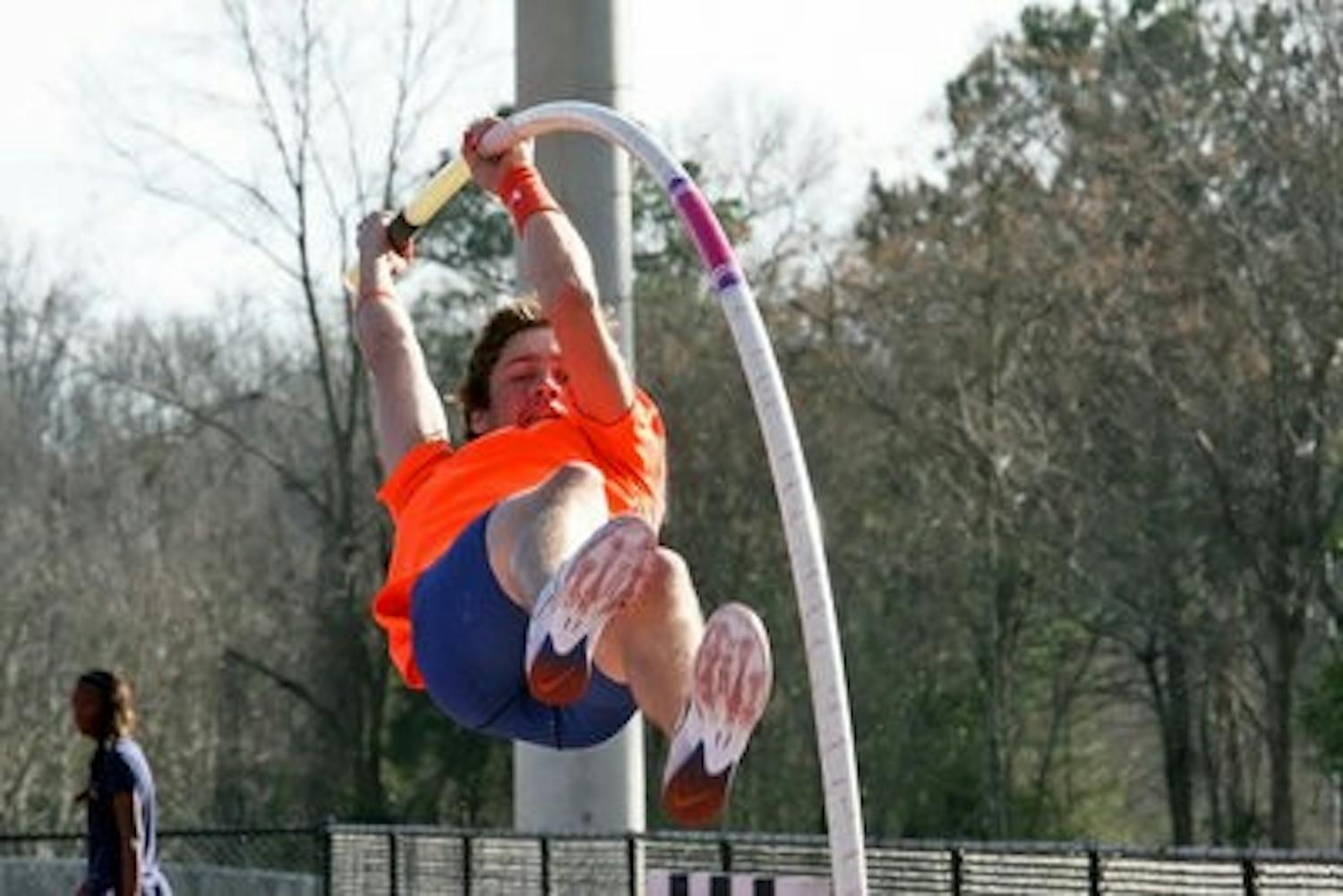 Freshman pole vaulter Chason Farnell practices his technique before the upcoming tournament Friday afternoon. (Rebecca Croomes / PHOTO EDITOR)