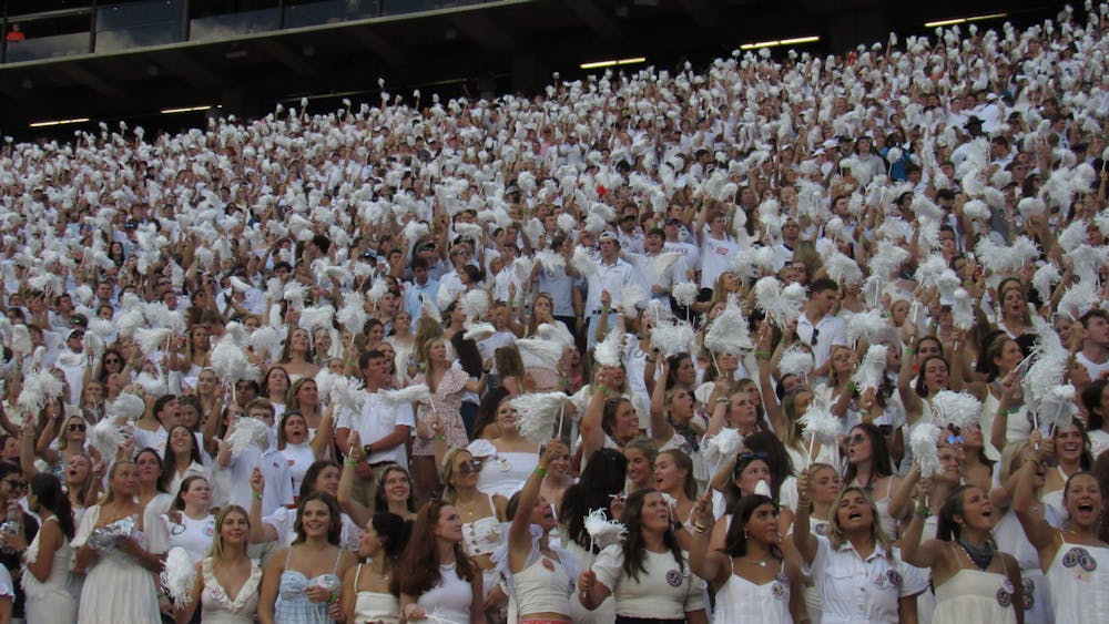 <p>Auburn students cheer on the tigers at a white-out themed game.&nbsp;</p>