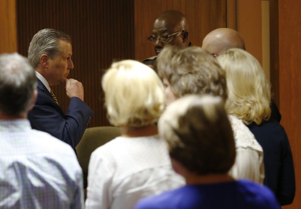 Mike Hubbard looks over at his wife Susan Hubbard while Lee County sheriffs deputies wait to take Hubbard into custody after found guilty on 12 of 23 counts on Friday, June 10, 2016  in Opelika, Ala. Todd J. Van Emst/Opelika-Auburn News/Pool