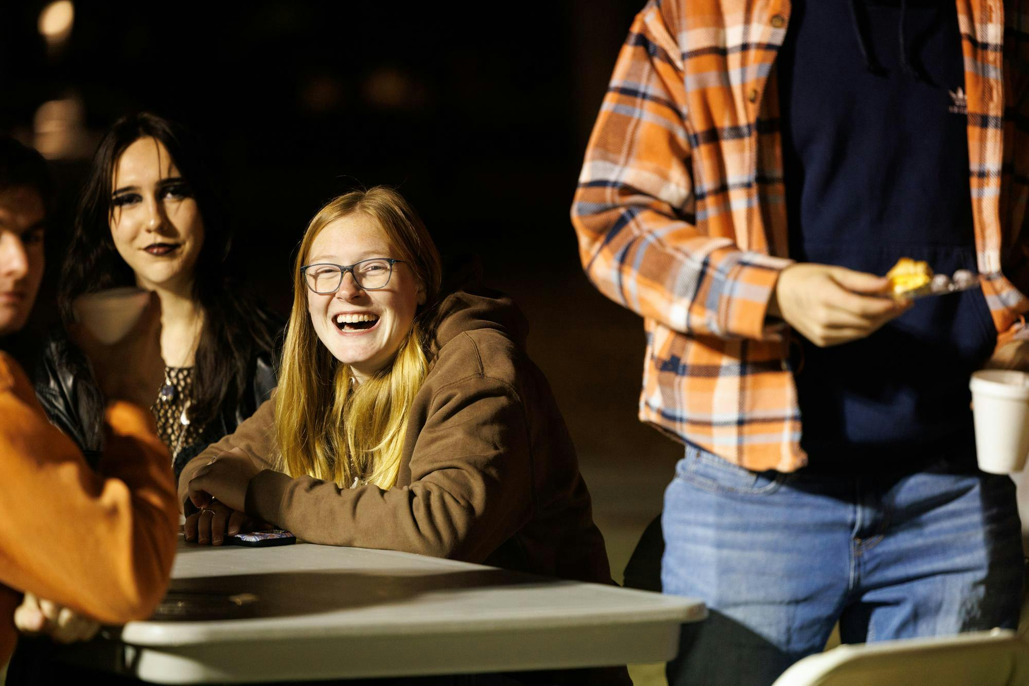 Attendees of the War Damn Coffee Jam laugh and hangout with one another on Samford lawn on Nov. 11, 2025.