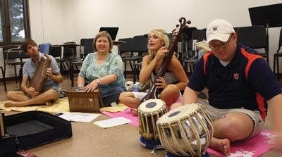 Students listen to Chaudhury before they begin playing another classical Indian melody. (Nicole Singleton / SPORTS EDITOR)