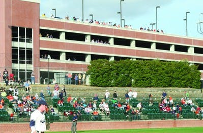 Numerous fans take in last week's baseball series against the Florida State Seminole from the parking deck between Plainsman Park and Jordan-Hare Stadium. The fans pictured had various opinions on why the location was better than purchased seats.