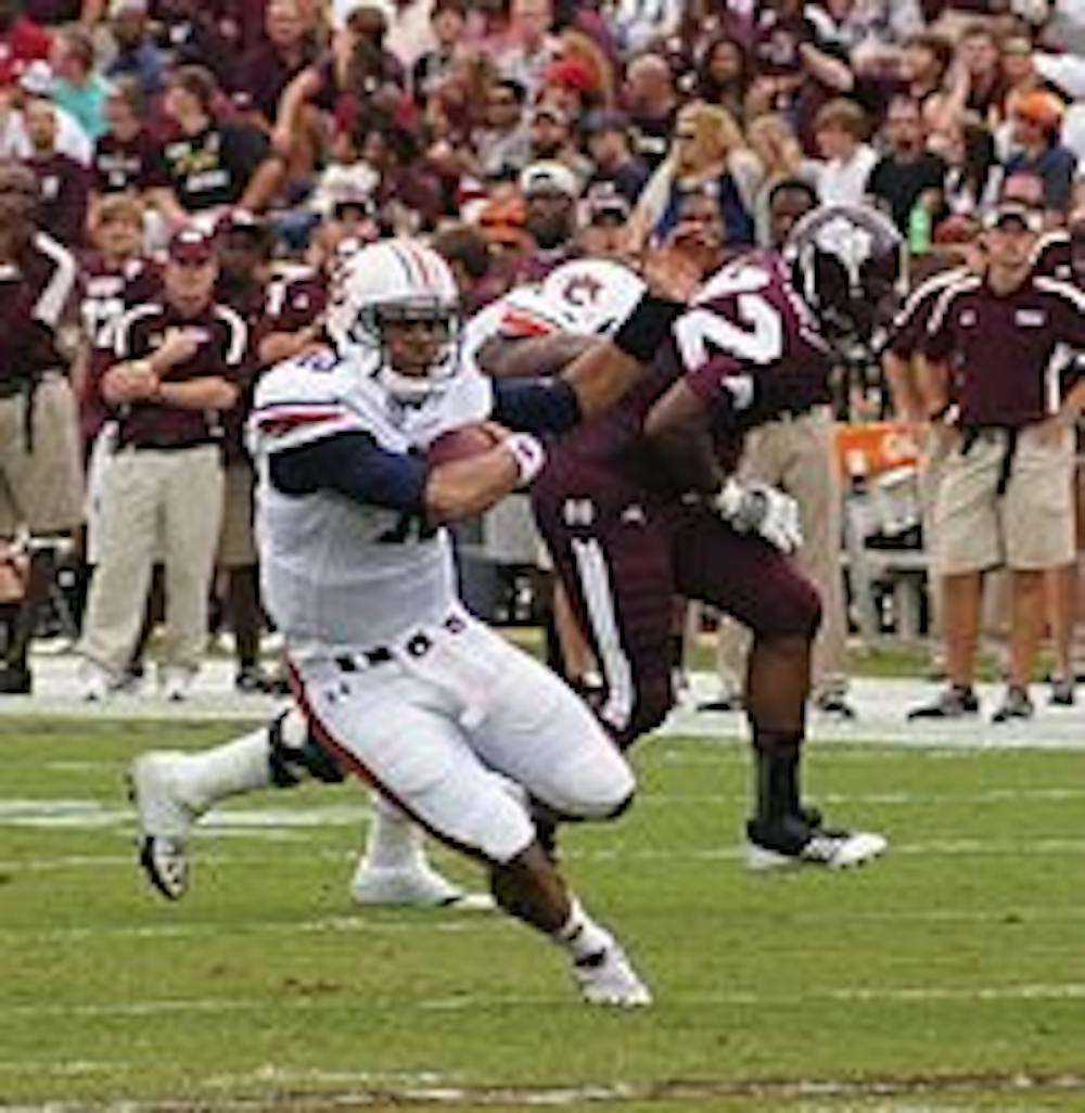 Quarterback Kiehl Frazier eludes defenders at Mississippi State. (Robert E. Lee / EDITOR-IN-CHIEF)