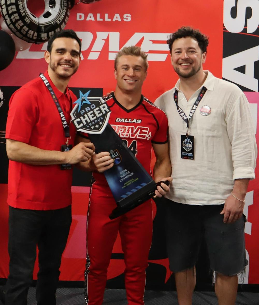 <p>Aleks Slavich poses with a trophy at the Professional Cheerleading Championship in Nashville, Tennessee. </p>