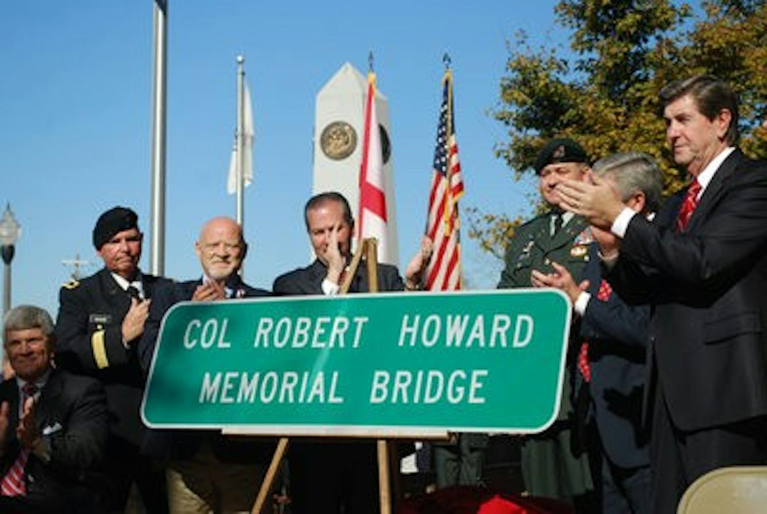 (Left to right) Steven Howard, servicemember, Rep. Mike Hubbard, Opelika Mayor Gary Fuller and Gov. Bob Riley unveil a bridge sign in honor of Vietnam War veteran Col. Robert Howard. (Jeremy Gerrard / Writer)