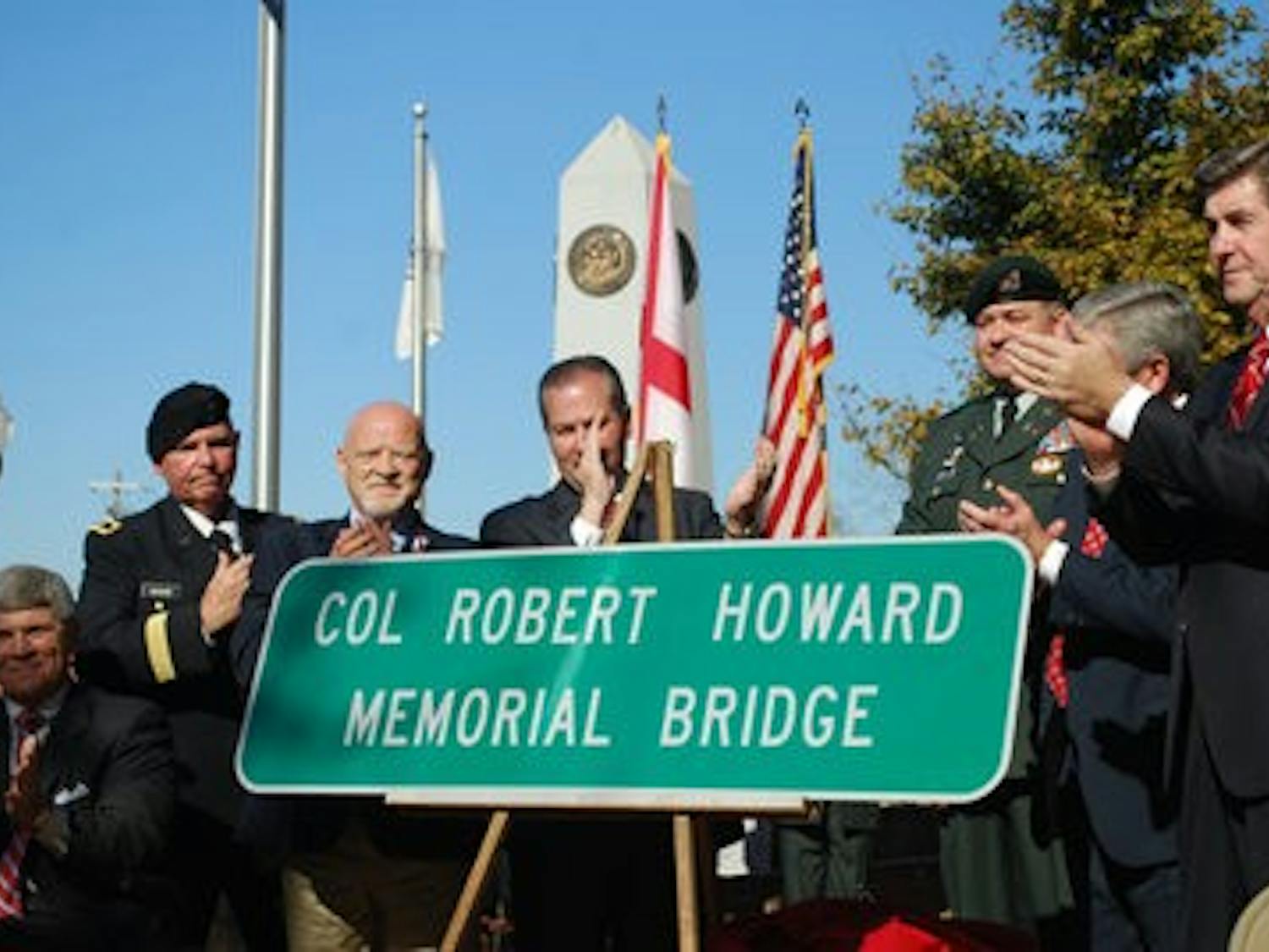 (Left to right) Steven Howard, servicemember, Rep. Mike Hubbard, Opelika Mayor Gary Fuller and Gov. Bob Riley unveil a bridge sign in honor of Vietnam War veteran Col. Robert Howard. (Jeremy Gerrard / Writer)