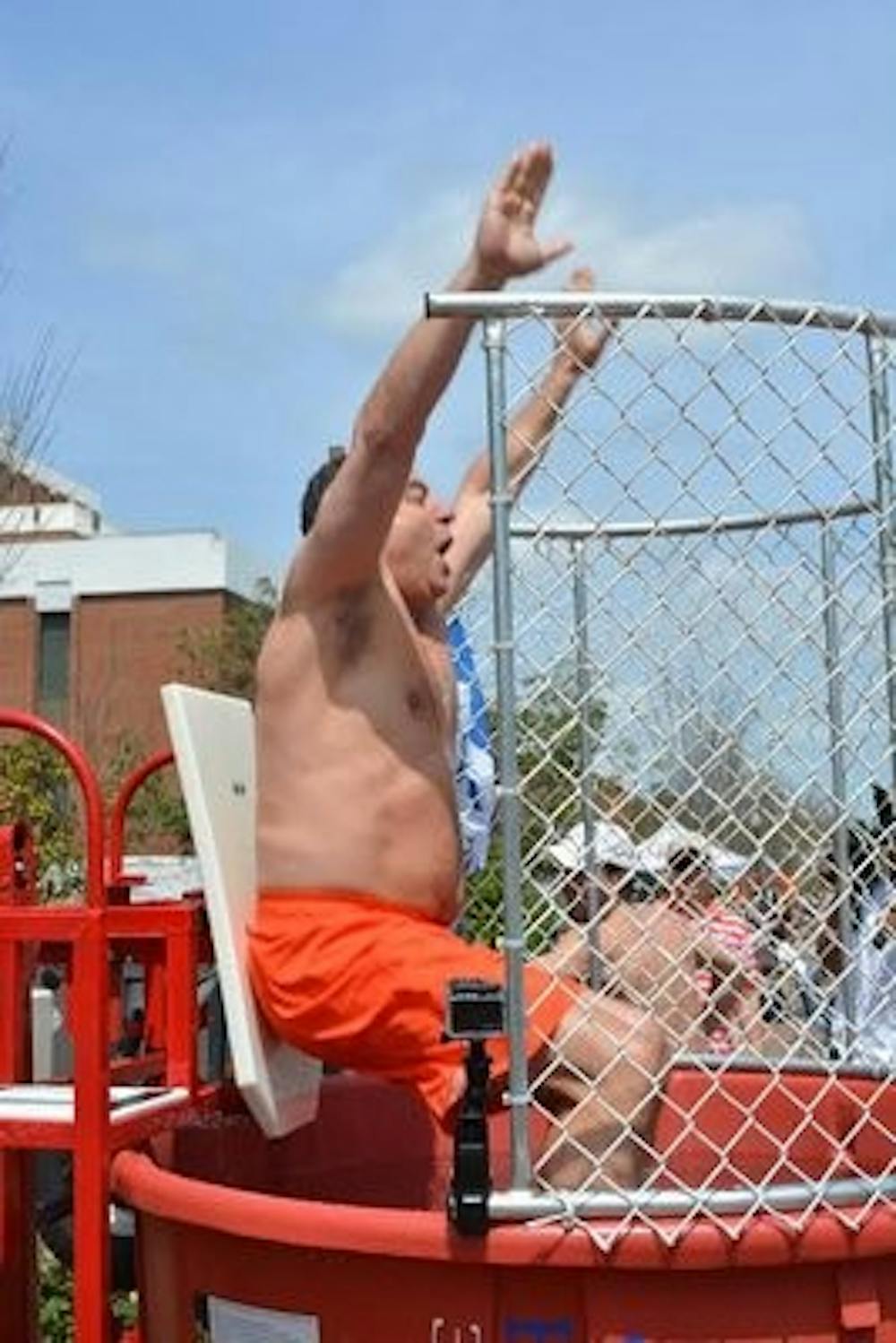 New men's basketball head coach Bruce Pearl goes underwater at the Pi Kappa Phi Dunk in front of the Student Center. (Raye May / DESIGN EDITOR)