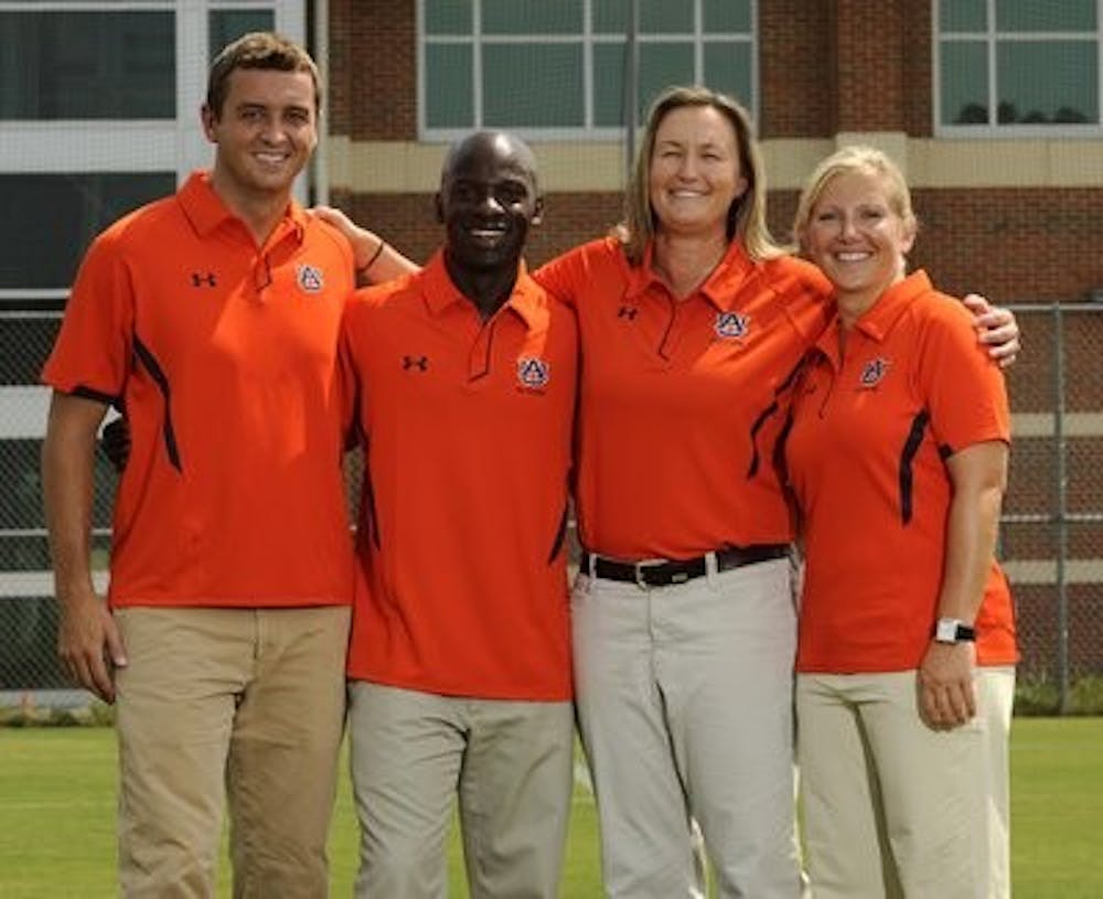 McAlpine stands with the other coaches of the Auburn women's soccer team. (Todd Van Emst / Media Relations)