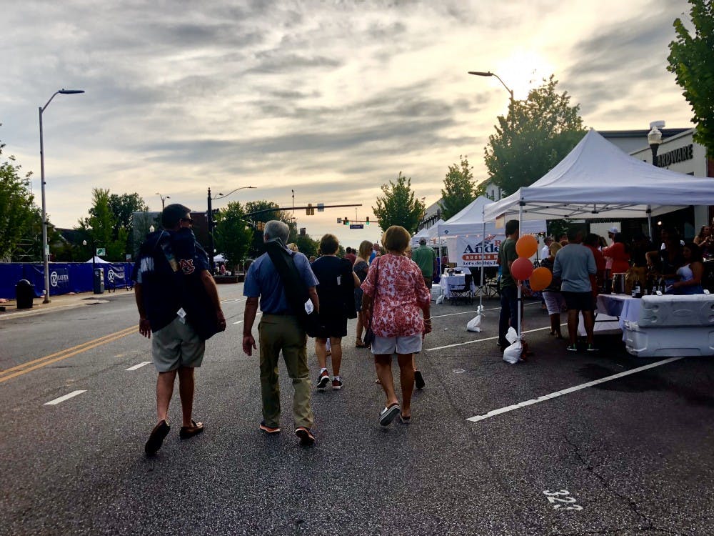 <p>Members of the Auburn community attend Cheers on the Corner on Friday, July 20, 2018 in Auburn, Ala.</p>