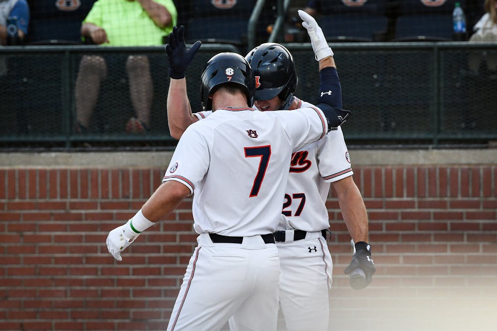 Auburn infielder Cole Foster (7) runs to first after hitting a