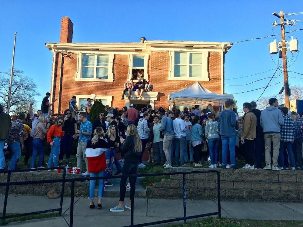 Students gather outside of Stephen Herrera's house on West Magnolia Avenue commonly referred to as "Pizza Frat."