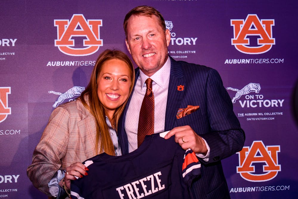 <p>Hugh Freeze celebrates with his family at his official introduction as Auburn's head coach at the Woltosz Football Performance Center on Nov. 29, 2022.</p>