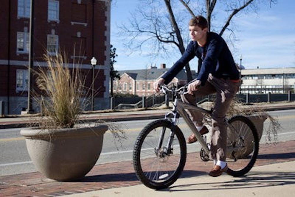 Cade Kistler rides his bicyle across campus. (Emily Adams/PHOTO EDITOR)