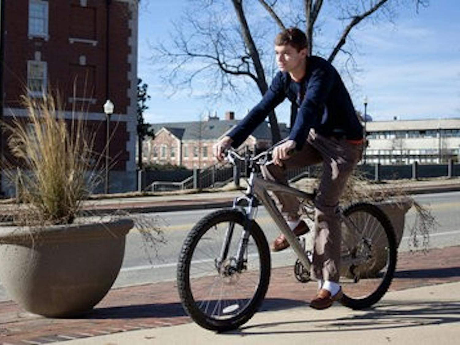 Cade Kistler rides his bicyle across campus. (Emily Adams/PHOTO EDITOR)