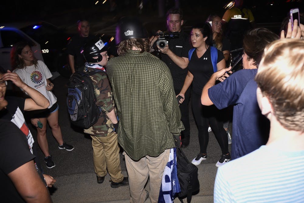 Alt-right protestors are confronted by students along Thach Avenue following alt-right leader Richard Spencer's talk on Tuesday, April 18, 2017 in Auburn, Ala. 