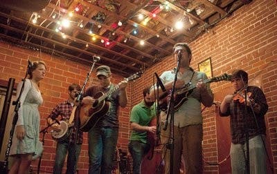 My Two Wings performed at Ale House Friday night. Their instruments include a guitar, mandolin, banjo and violin. (Emily Adams / Photo Editor)