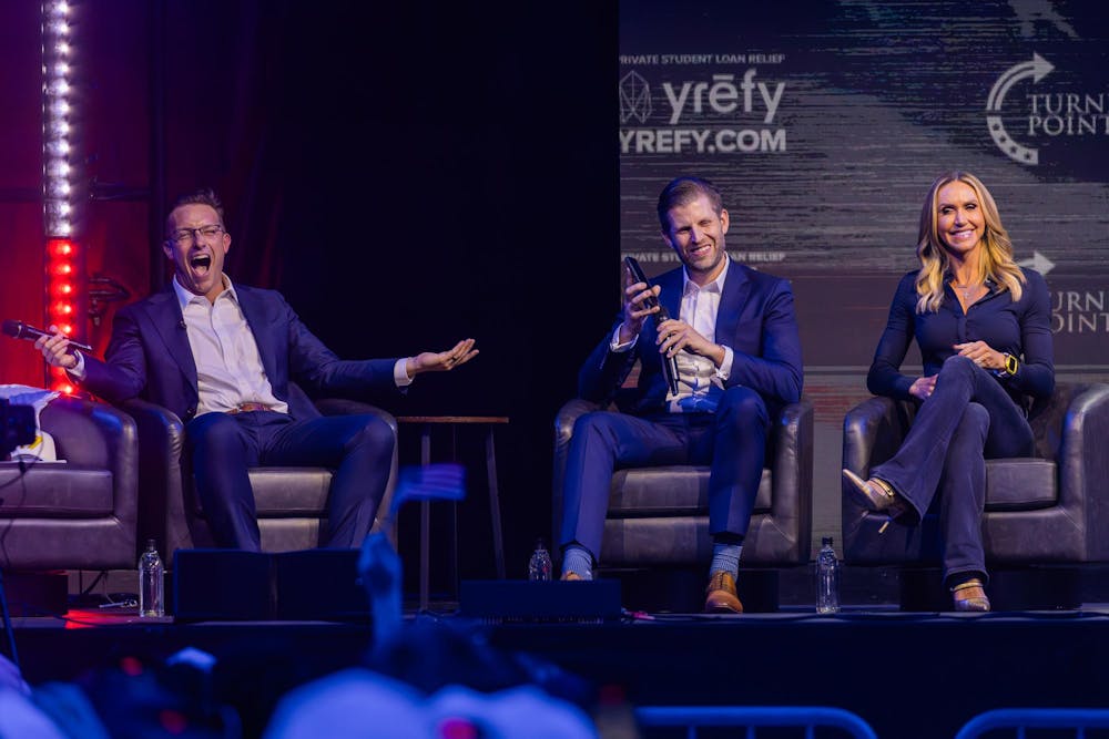 Benny Johnson reacts as Eric Trump calls his father, President Donald Trump, during a Turning Point USA event on Nov. 5, 2025.