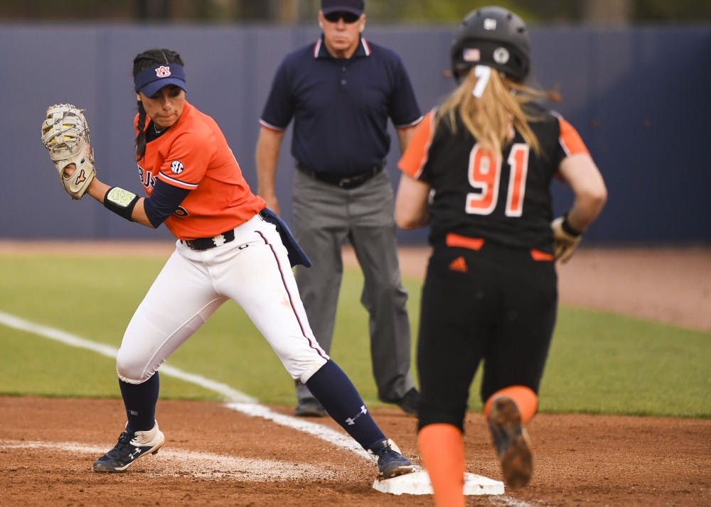 <p>Justus Perry (18) tags first base during Auburn softball vs. Mercer on March 8, 2019, in Auburn, Ala.</p>