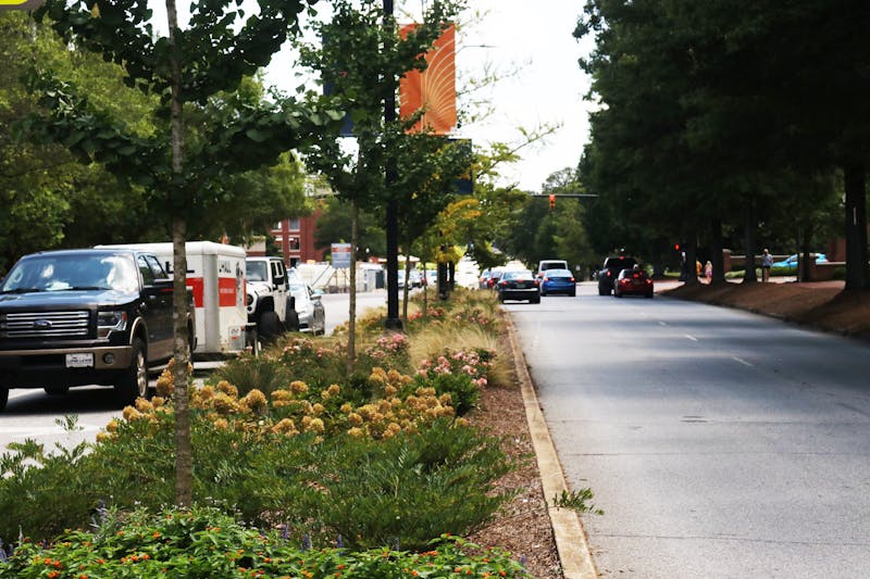 Cars pass by Auburn University on South College Street during a busy move-in season on Friday, Aug. 13, in Auburn, Ala.