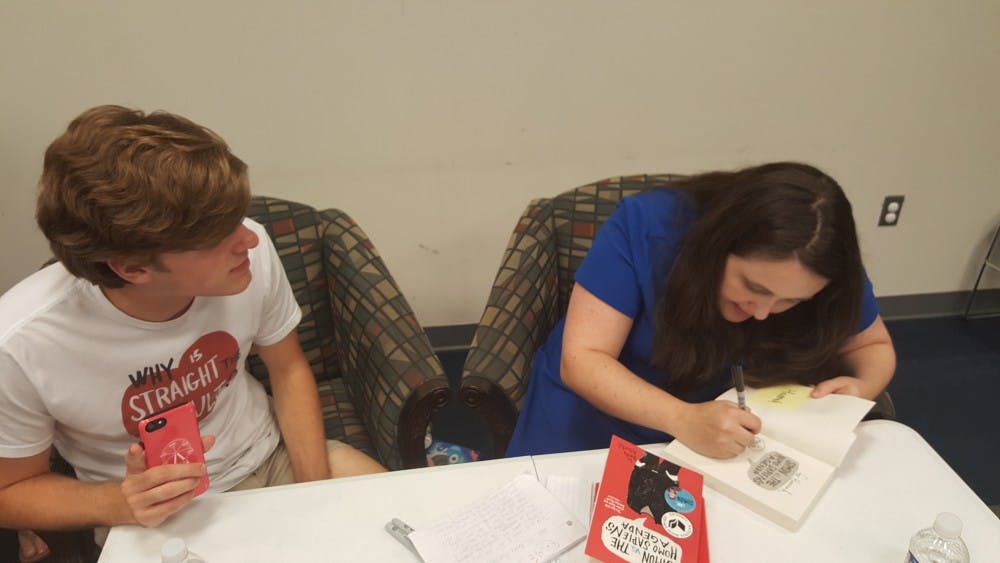 <p>Matthew Epperd (left) and Becky Albertalli (right) chat during a book signing at the Auburn Public Library on Aug. 26, 2018 in Auburn, Ala.</p>