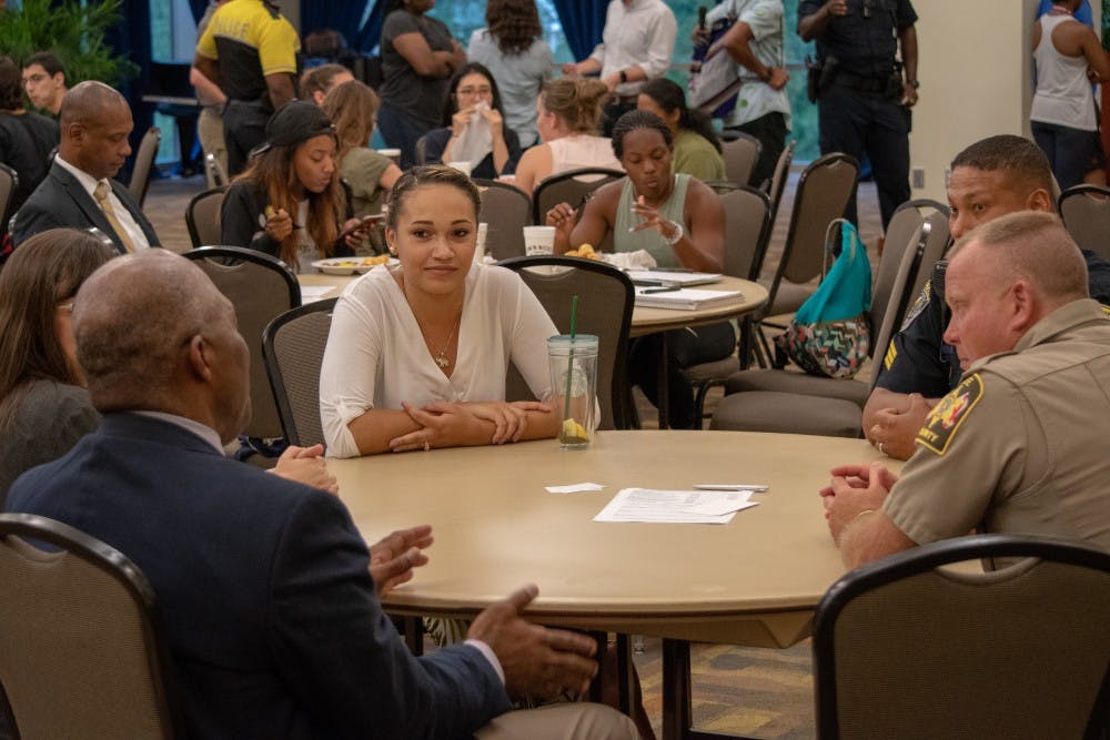 <p>Members of the public speak with local law enforcement officers during the Together We Can event on Teusday, Sept. 4, 2018, in Auburn, Ala.</p>