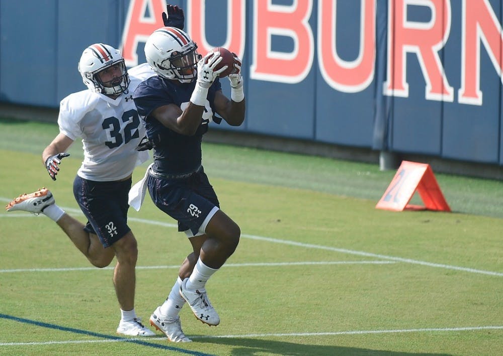 Harold Joiner (29) hauls in a pass over Sam Sherrod (32). Photo courtesy of Auburn football on Instagram (@AuburnFootball).