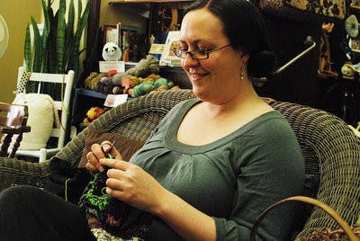Cary Curtiss knits a brightly colored cowl. (Emily Enfinger / Photographer)