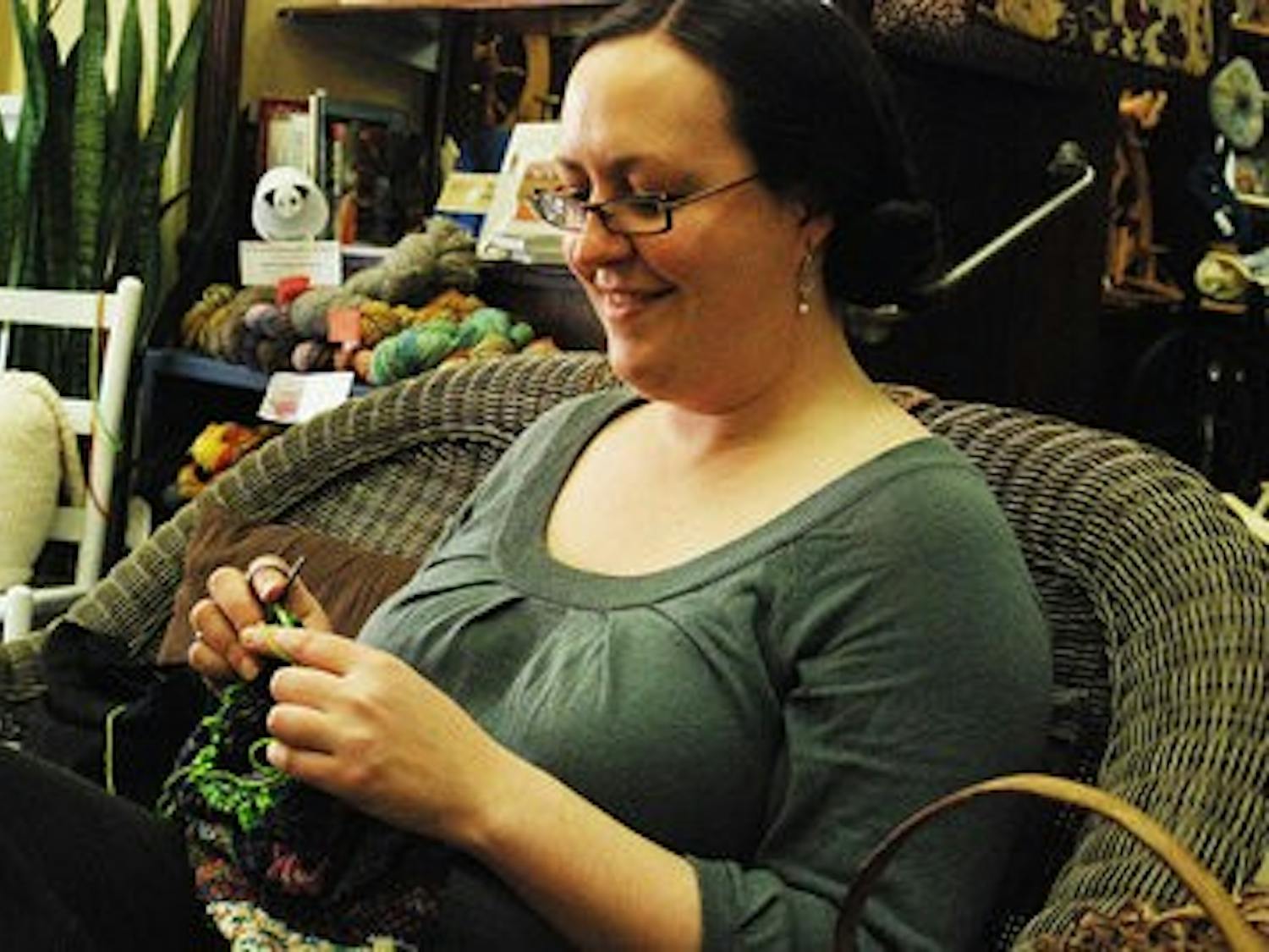 Cary Curtiss knits a brightly colored cowl. (Emily Enfinger / Photographer)