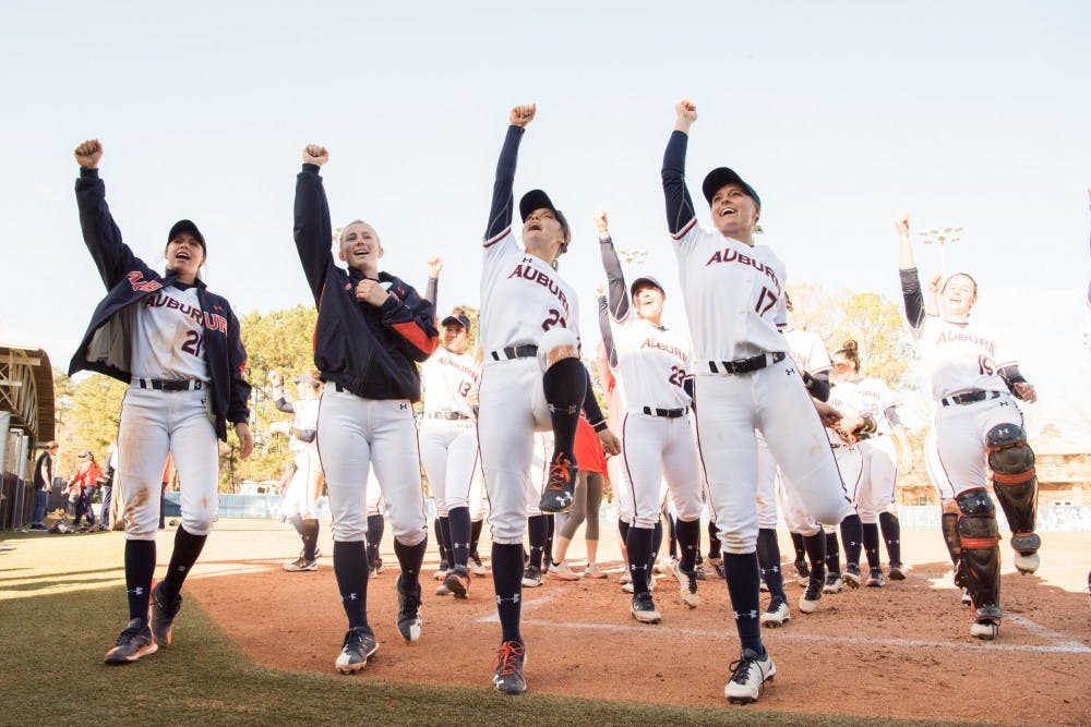 The Auburn softball team sings "War Eagle" after their 6-1 win over UNCW on Sunday, Mar. 4, 2018, in Auburn, Ala.