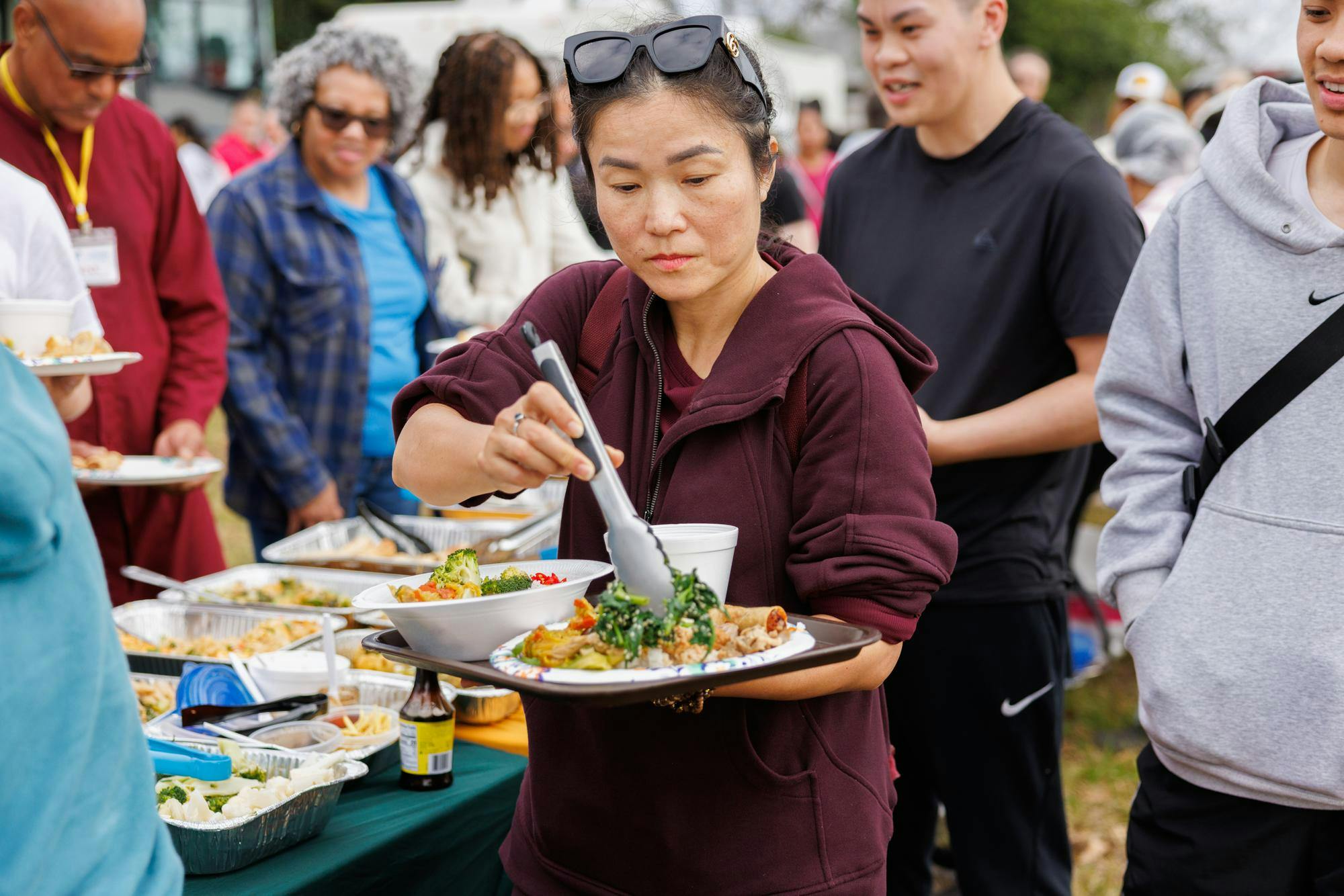 Volunteers are second in line, after the monks, to grab plates and bowls of food. There was a wide selection of rice, vegetables, fruits, meats and desserts for everyone to pick from. After the volunteers, the supporters and guest were encouraged to grab food.