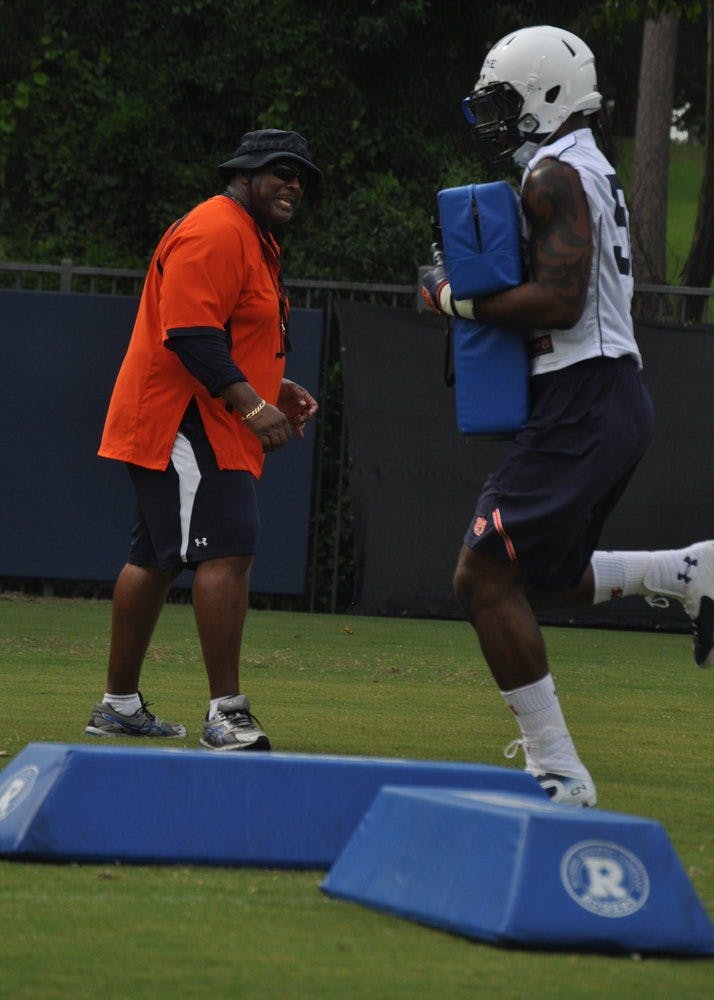 Defensive end Justin DeLaine gets instructions from defensive line coach Rodney Garner.
Anna Grafton / ASSOCIATE PHOTO