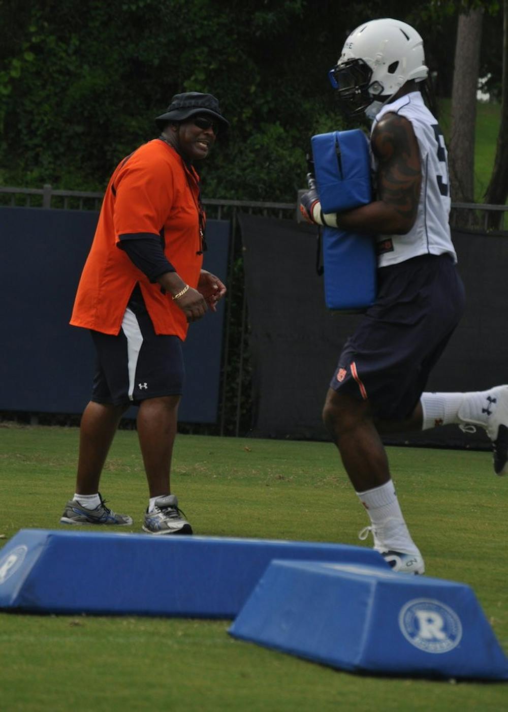 Defensive end Justin DeLaine gets instructions from defensive line coach Rodney Garner.
Anna Grafton / ASSOCIATE PHOTO