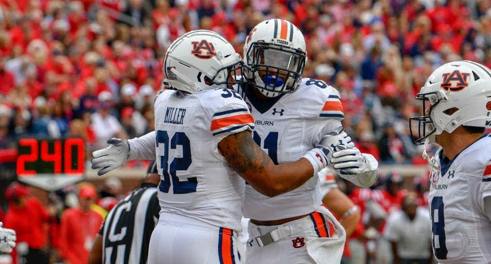 <p>Malik Miller (32) celebrates his touchdown with Darius Slayton (81) during Auburn football vs. Ole Miss on Oct. 20, 2018, in Oxford, Miss.</p>