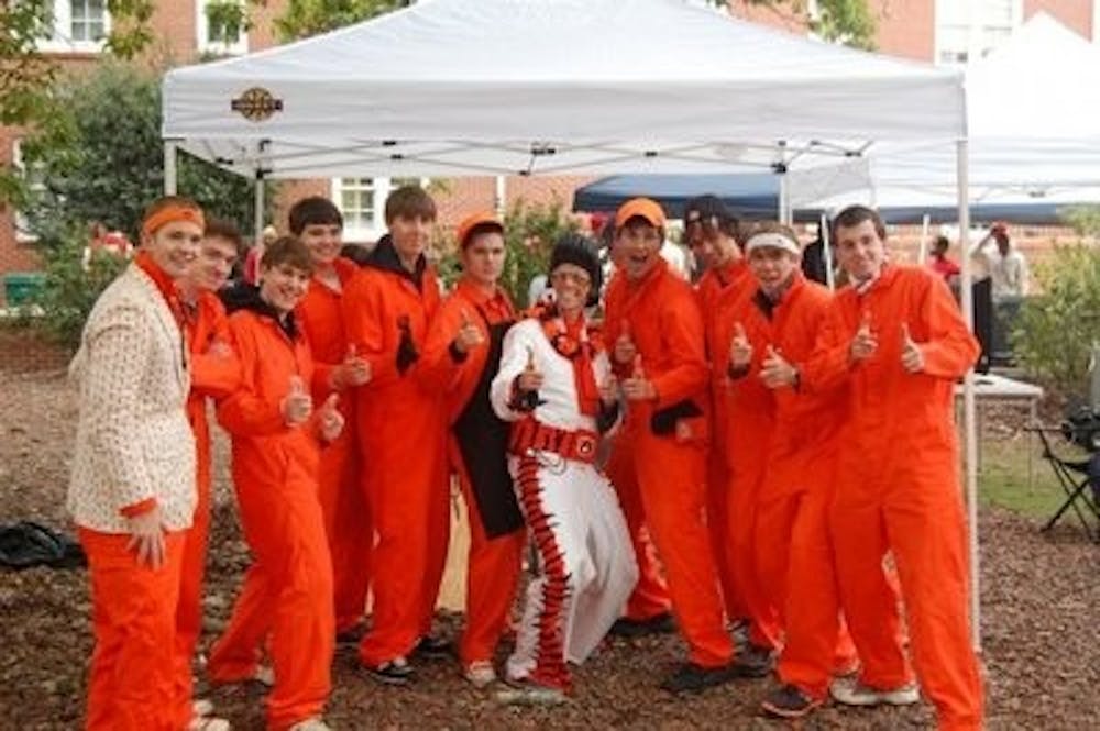 The Orange Jumpsuit Guys celebrate an Auburn victory while tailgating by Lupton Hall. (CONTRIBUTED)
