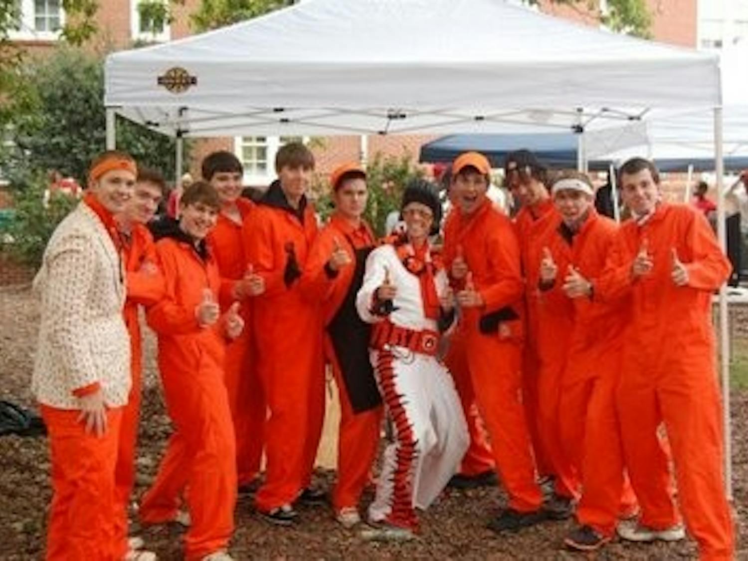 The Orange Jumpsuit Guys celebrate an Auburn victory while tailgating by Lupton Hall. (CONTRIBUTED)