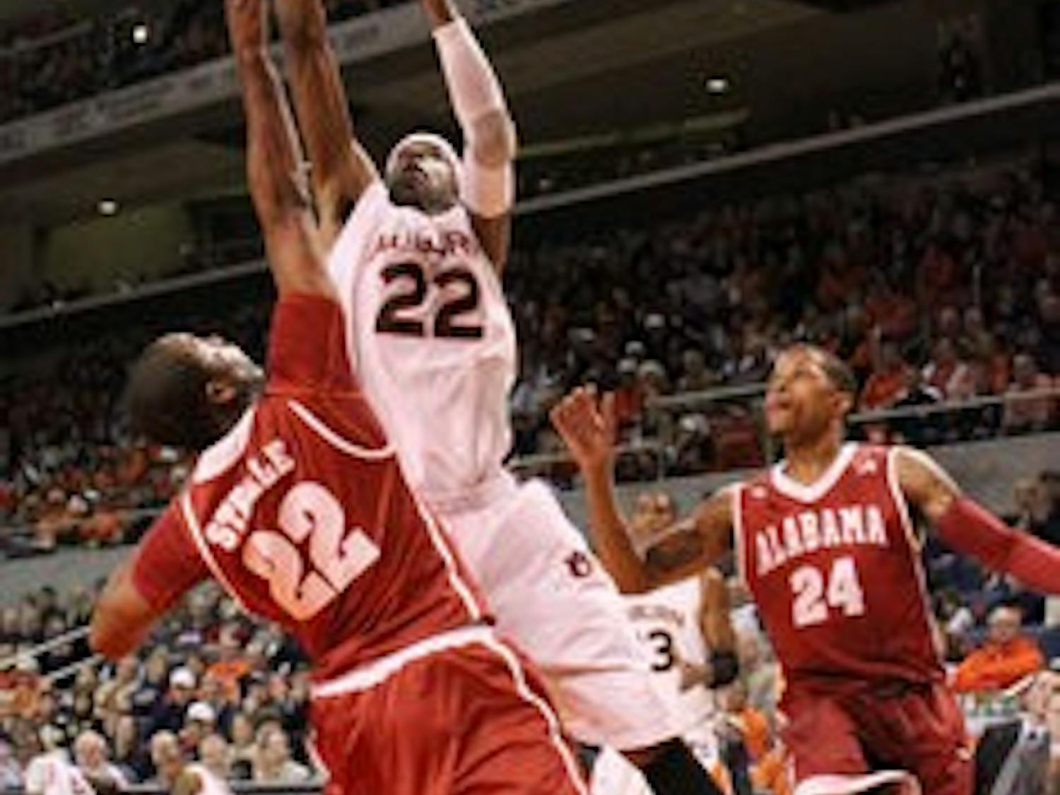 Junior forward Kenny Gabriel stretches to shoot the ball. (Emily Adams / Photo Editor)