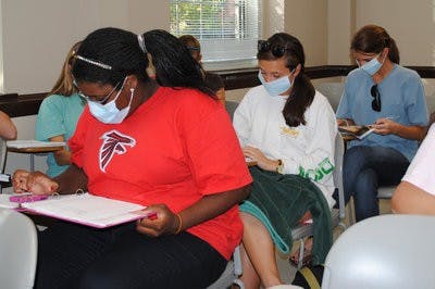 To stay protected from airborn viruses, students wear surgical masks during class. (Elaine Busby / ASSISTANT PHOTO EDITOR)