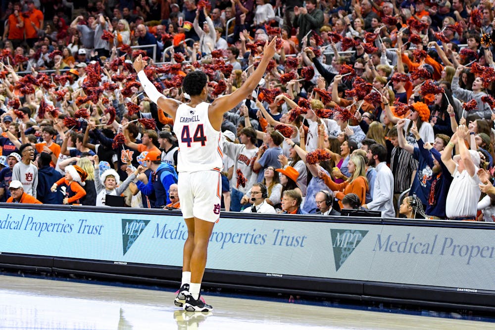 Auburn center Dylan Cardwell (44) greets the crowd after a two-point play during the second half against the University of South Florida in Neville Arena on Nov. 11, 2022.