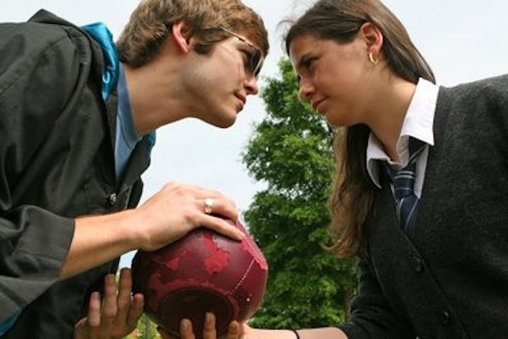 Katie Guthier, right, sophomore in industrial engineering and Spanish, and Michael Lambert, junior in wildlife ecology and management, face off for the quaffle, a ball in play in the mythical sport of quidditch from the Harry Potter series. In the last decade, qudditch has been adapted and played at colleges across the U.S. Engineers Without Borders will be hosting a quidditch tournament April 21 to raise funds for the "Bolivia Project." (Rebecca Croomes / PHOTO EDITOR)