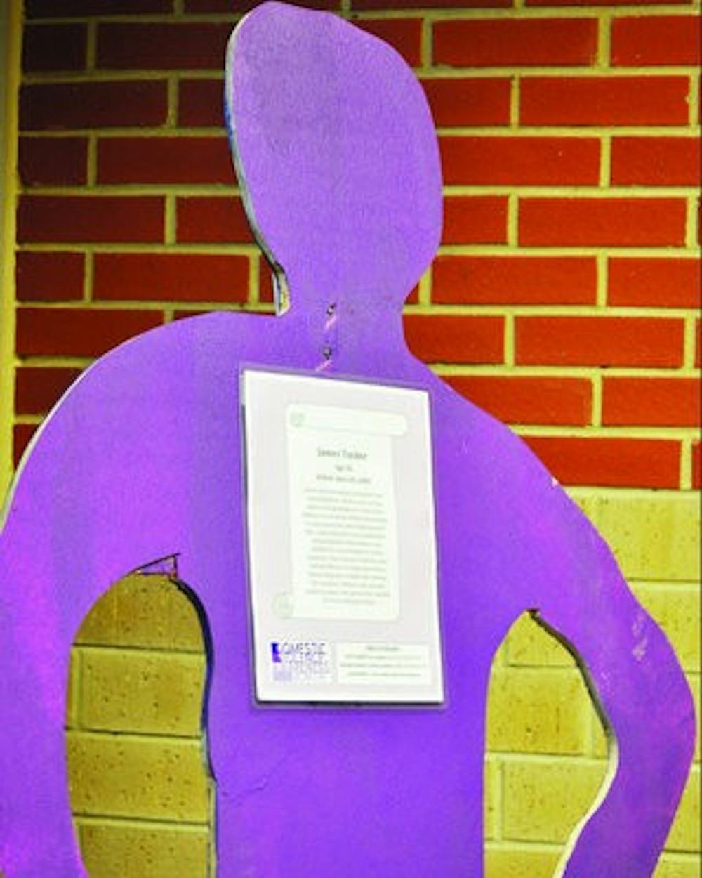 Domestic Violence Awareness Month cut-outs stand  proud in the Student Center. (Katie Wittnebel / PHOTO STAFF)