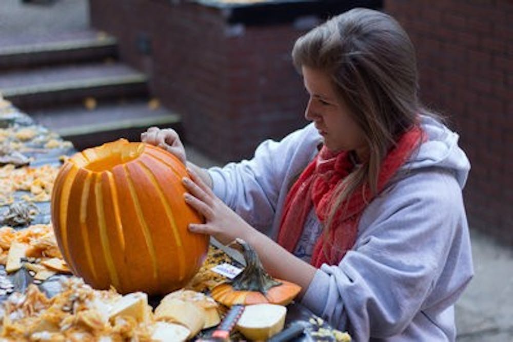 Mary Margaret Jenrath, sophomore in architecture, works on her pumpkin.