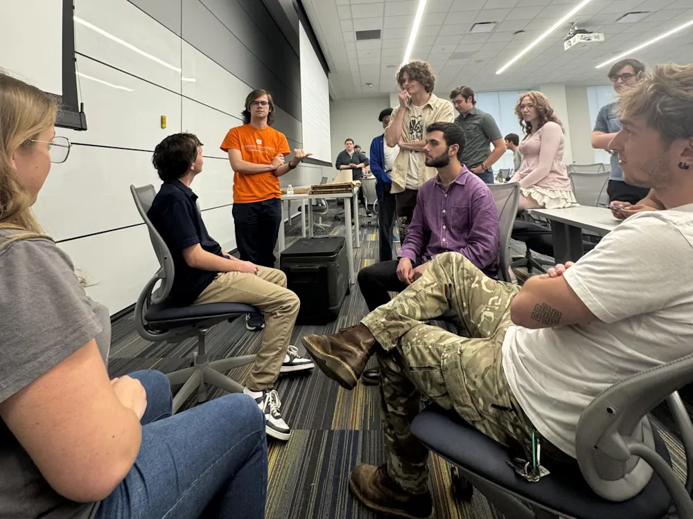 Students at the "Engaging Iran: Policy, Intelligence & Regional Stakes" sit in chairs arranged in a circle to debate their beliefs on the ongoing military operation. Contributed by AUNSIS.